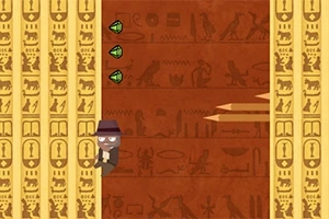 Animaatiohahmo kiipeää hieroglyfeillä koristeltua muuria ylös savu-smaragdejen ja kahden ulkonevan, puiselta näyttävän esteen vieressä