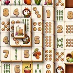 Mahjong-laattoja, joissa on numeroita ja syksyaiheisia kuvia kuten kynttilöitä, vihanneksia ja lehtiä